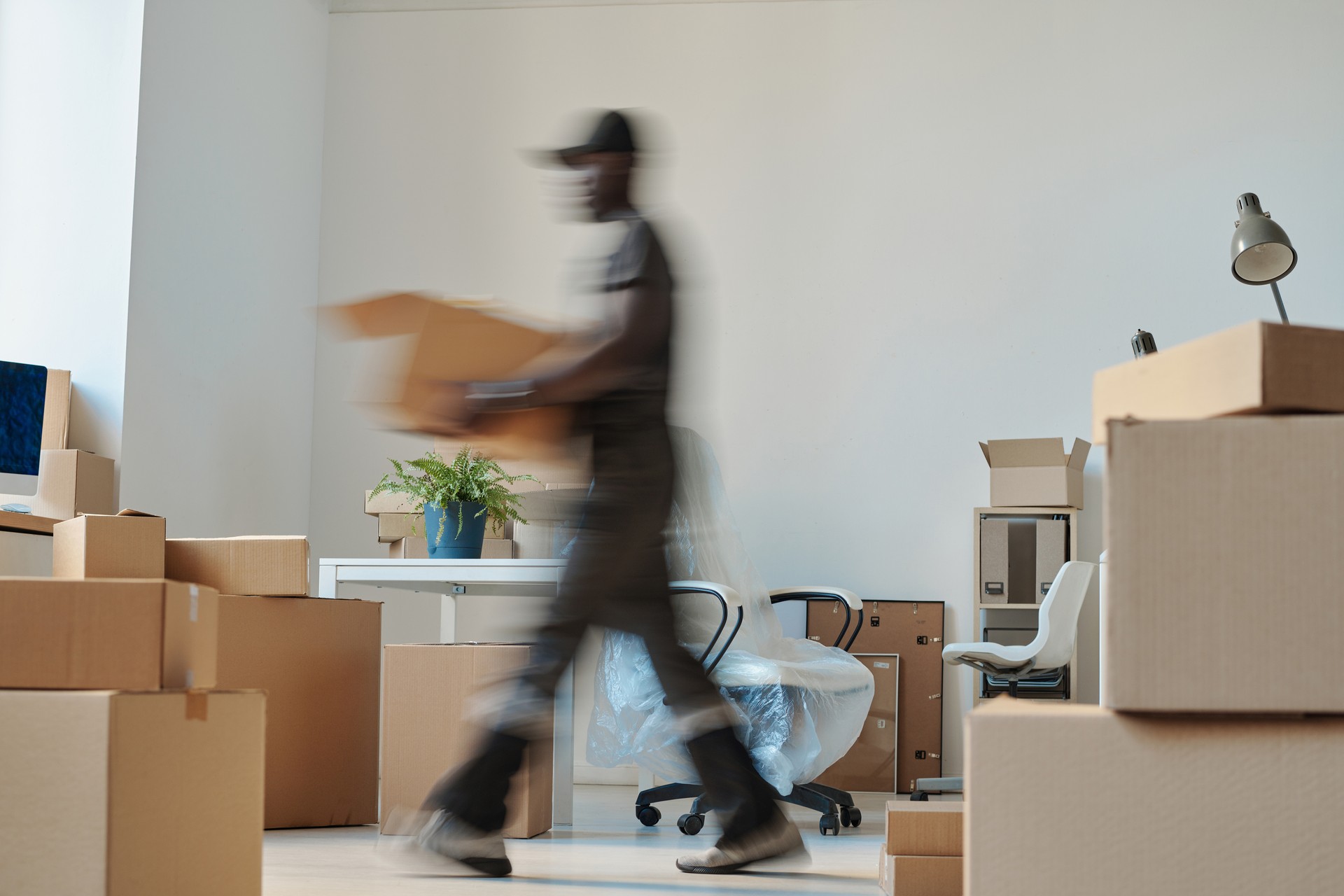 Worker carrying boxes during relocation